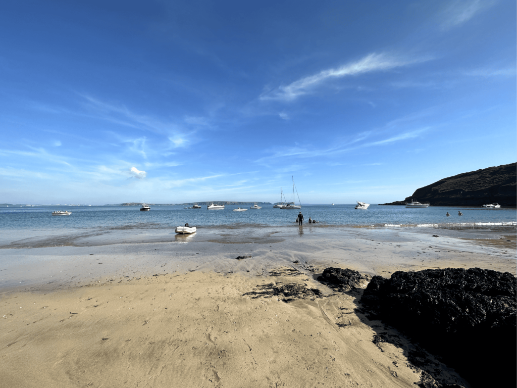 A picturesque sandy beach with soft golden sand and calm waves, perfect for a relaxing day in the sun.